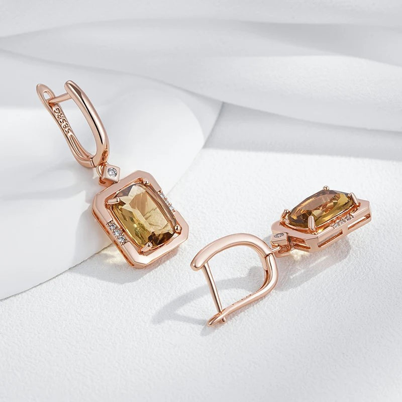 Champagne square drop earrings with one hinged lever-back hoop open to show the closure