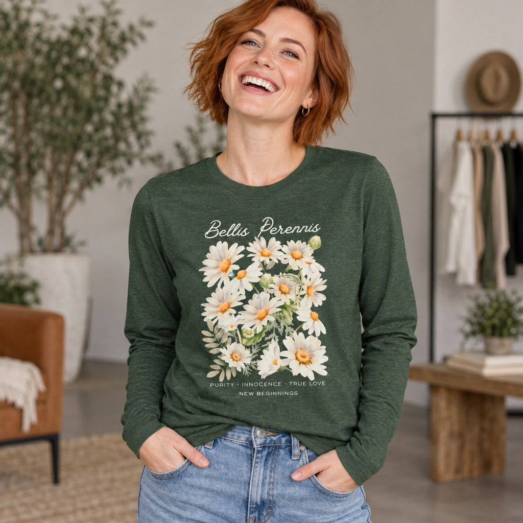 Woman in a heather forest green Bella Canvas 3501 long sleeve shirt featuring a soft watercolor bouquet of Bellis perennis daisies, elegant floral lettering and symbolic text, cozy home environment, cottagecore aesthetic, perfect for flower symbolism lovers, brides, and those embracing new beginnings, by Crossroads Dandelion