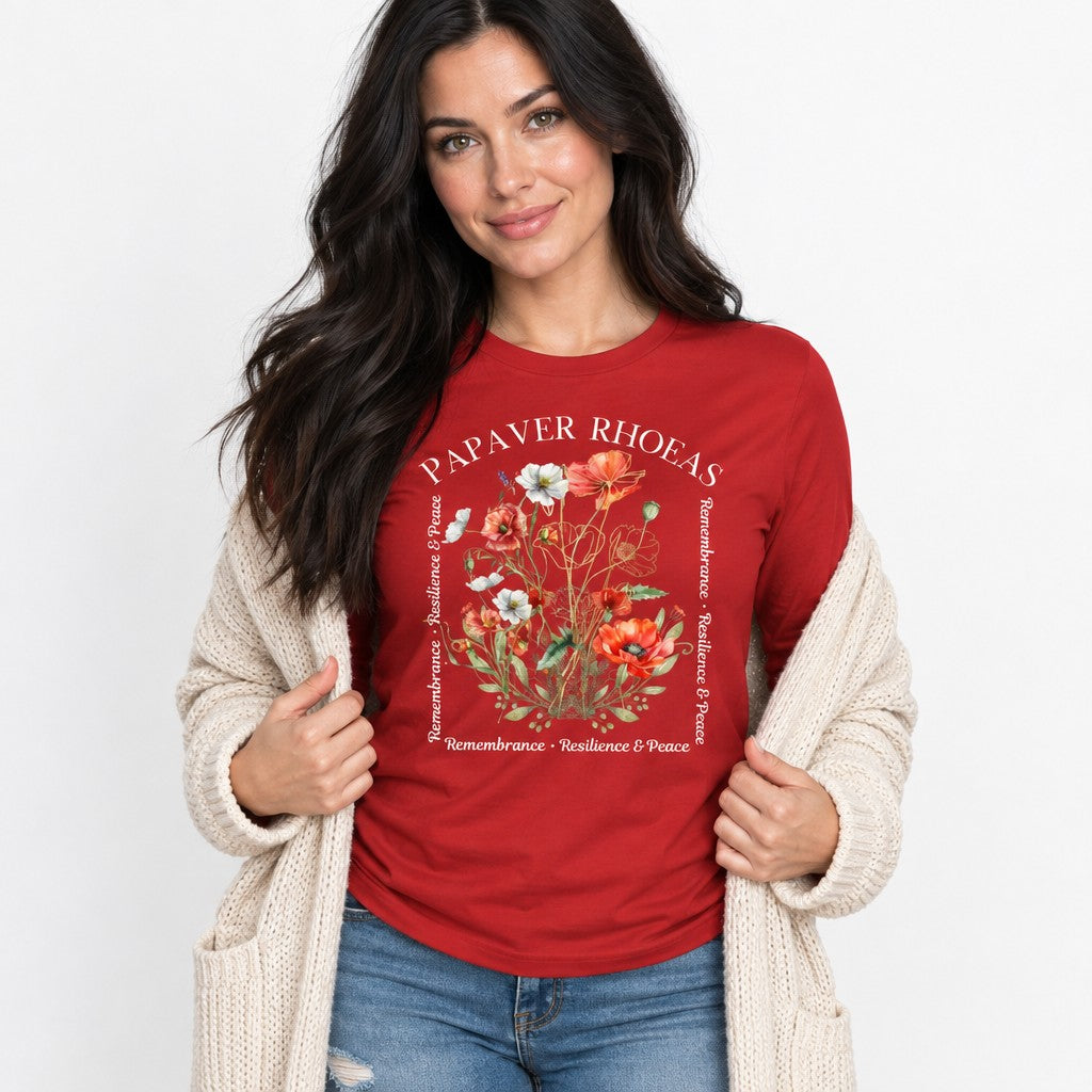 Woman in red Bella Canvas 3501 long sleeve shirt featuring a watercolor poppy bouquet with golden botanical lines and poetic text, cottagecore floral aesthetic, designed for nature-loving women, by Crossroads Dandelion
