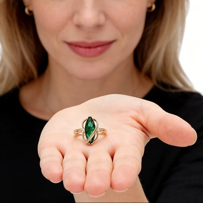 Woman holding the green leaf ring in rose gold in her open palm
