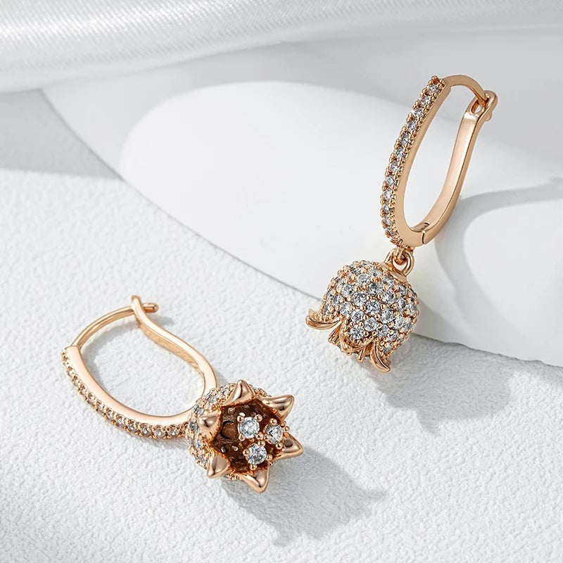 Lily of the valley earrings with one hinged hoop open, showing the flower from below