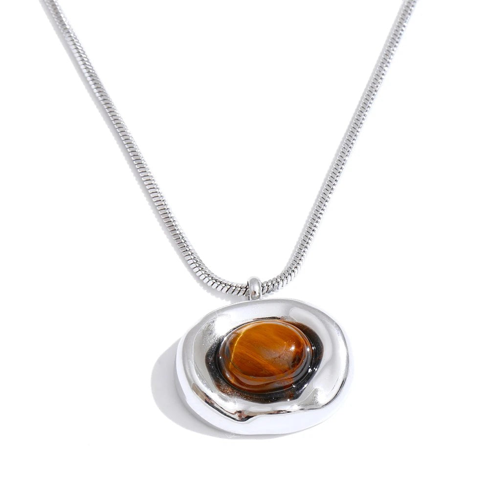 Silver-tone organic pebble pendant with a tiger eye cabochon on a snake chain, front view