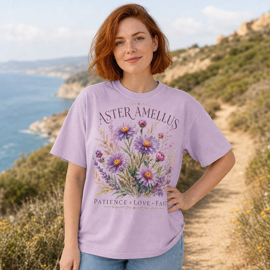 Woman wearing an Comfort Colors orchid color t-shirt with a beautiful Aster floral design and the latin name for the flower and meaning.