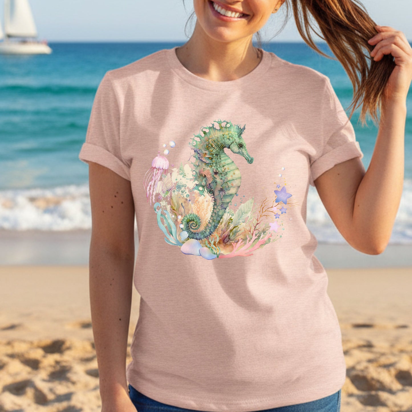 Woman wearing an Ocean seahorse shirt in heather peach at a beach
