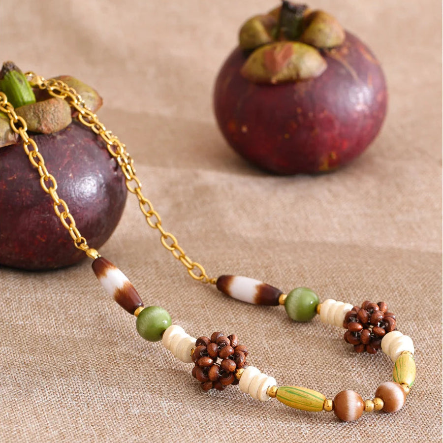 Rustic fall necklace with natural elements on a textured surface
