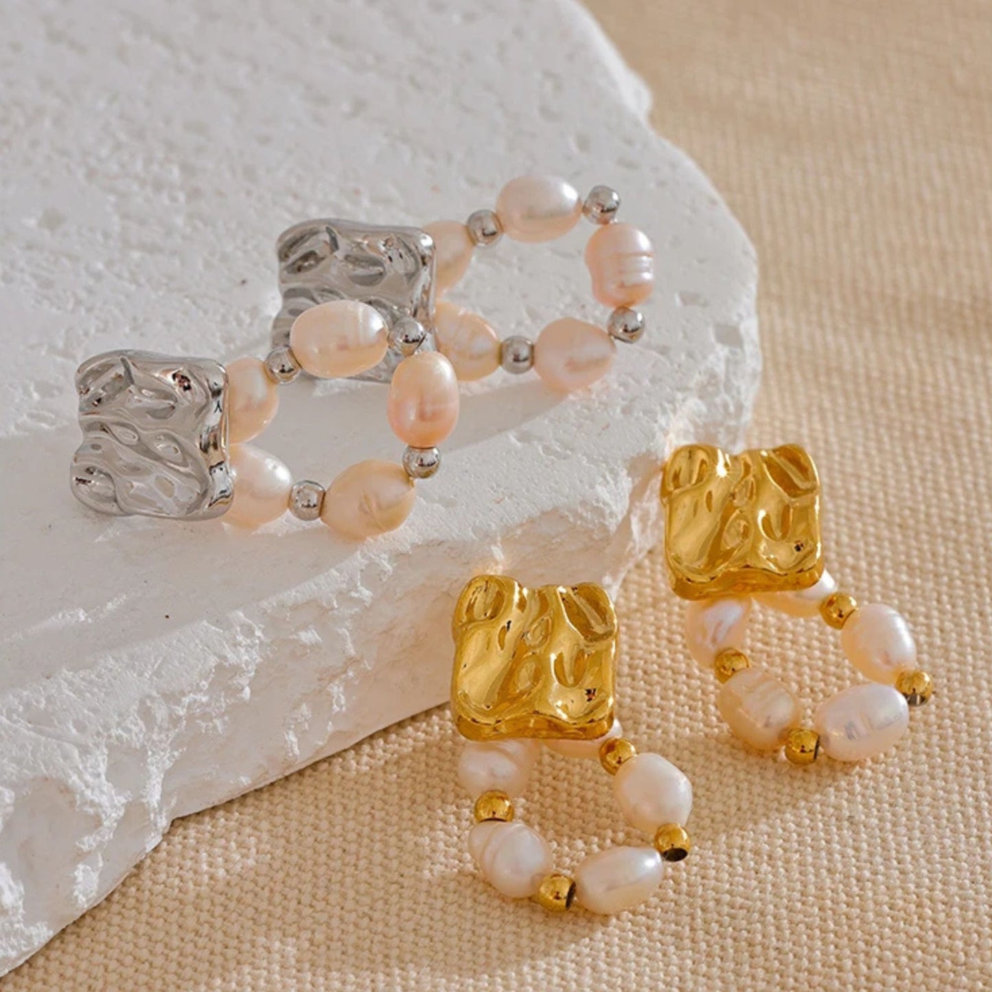 Close-up of baroque freshwater pearl  in stainless steel and gold pleated finish, gold bead hoop dangle earrings with geometric gold stud top, rust-proof stainless steel, by Crossroads Dandelion