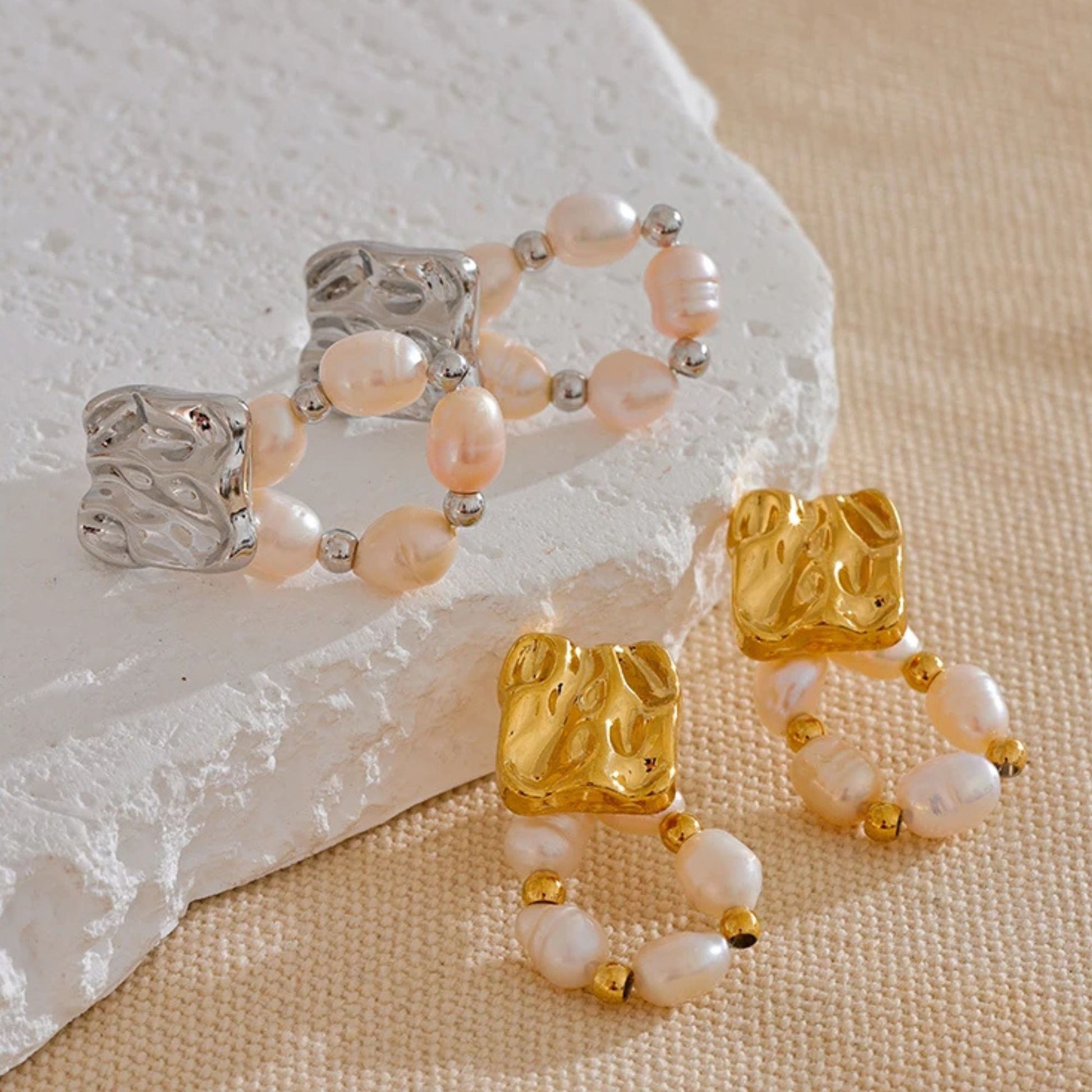 Close-up of baroque freshwater pearl  in stainless steel and gold pleated finish, gold bead hoop dangle earrings with geometric gold stud top, rust-proof stainless steel, by Crossroads Dandelion