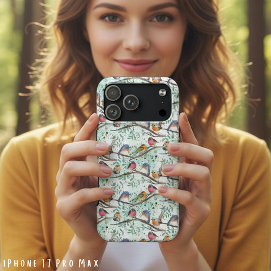 Woman holding an iPhone 17 Pro Max case with a floral and branches case featuring birds in a natural setting