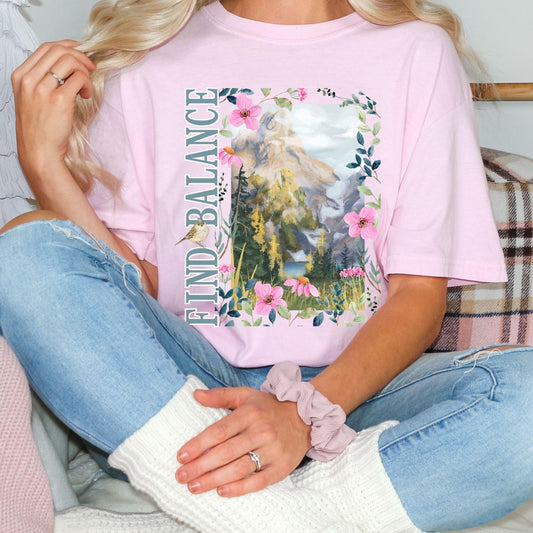 Woman wearing a Comfort Colors t-shirt in Blossom color with relaxed lifestyle aesthetic and premium casual apparel styling, Wildflower graphic vintage tee by Crossroads Dandelion