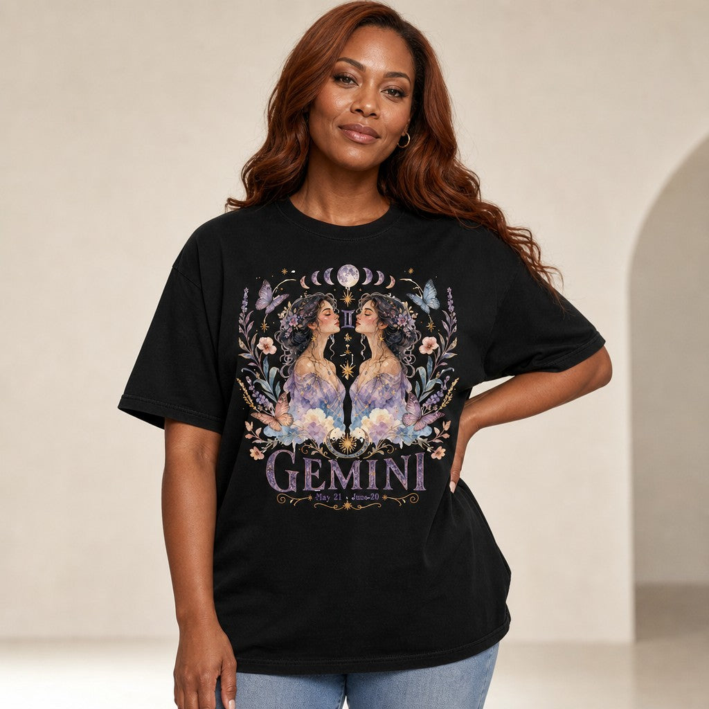 Woman wearing black Comfort Colors 1717 t-shirt with whimsical boho Gemini design featuring watercolor twin women, celestial jewelry, pastel butterflies, flowers, and moon phases, dreamy zodiac vibe for astrology lovers, by Crossroads Dandelion