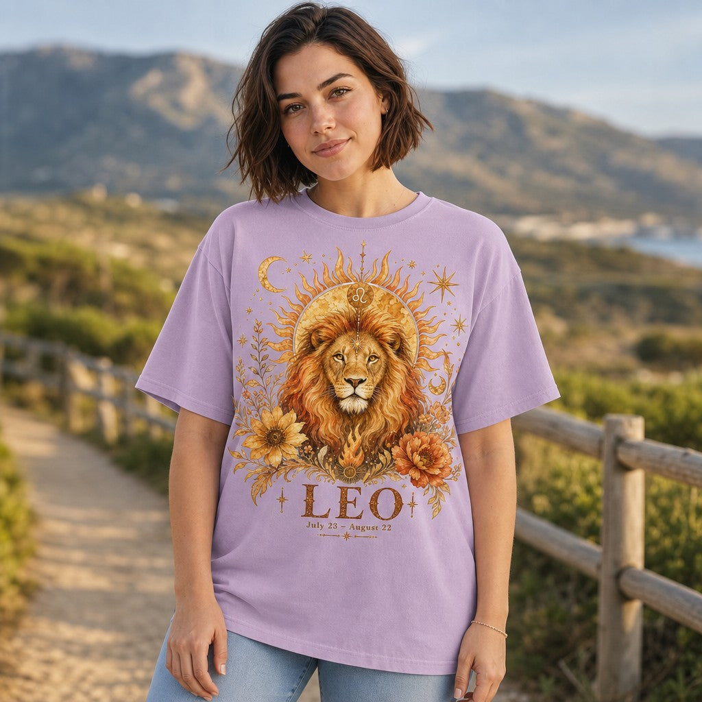 Woman in orchid Comfort Colors 1717 t-shirt featuring a mystical boho watercolor Leo lion portrait crowned by a sun and surrounded by stars, moons, sunflowers, and peonies, standing on an outdoor trail, zodiac gift for women, by Crossroads Dandelion