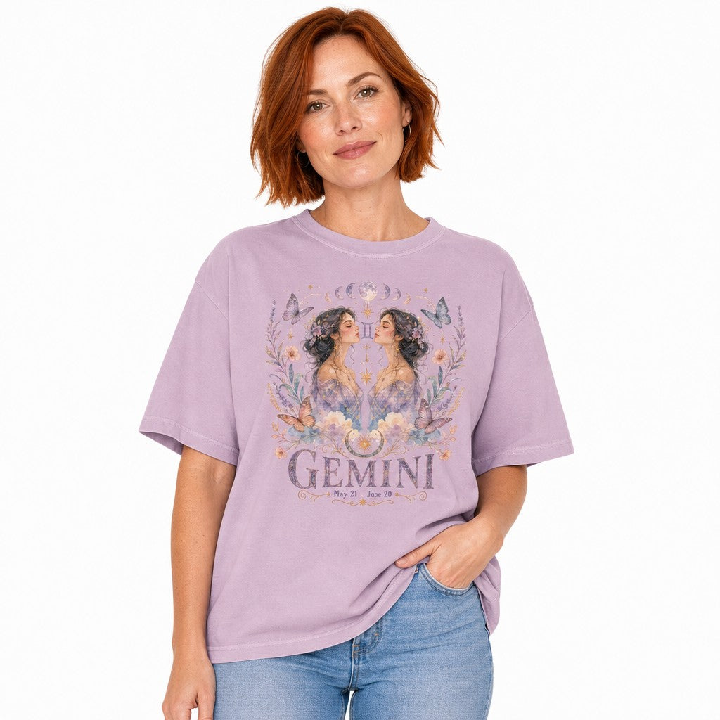 Woman wearing an orchid Comfort Colors 1717 t-shirt with a whimsical boho Gemini design featuring twin women, celestial jewelry, pastel butterflies, flowers, and moon phases in watercolor style, perfect for astrology lovers, by Crossroads Dandelion