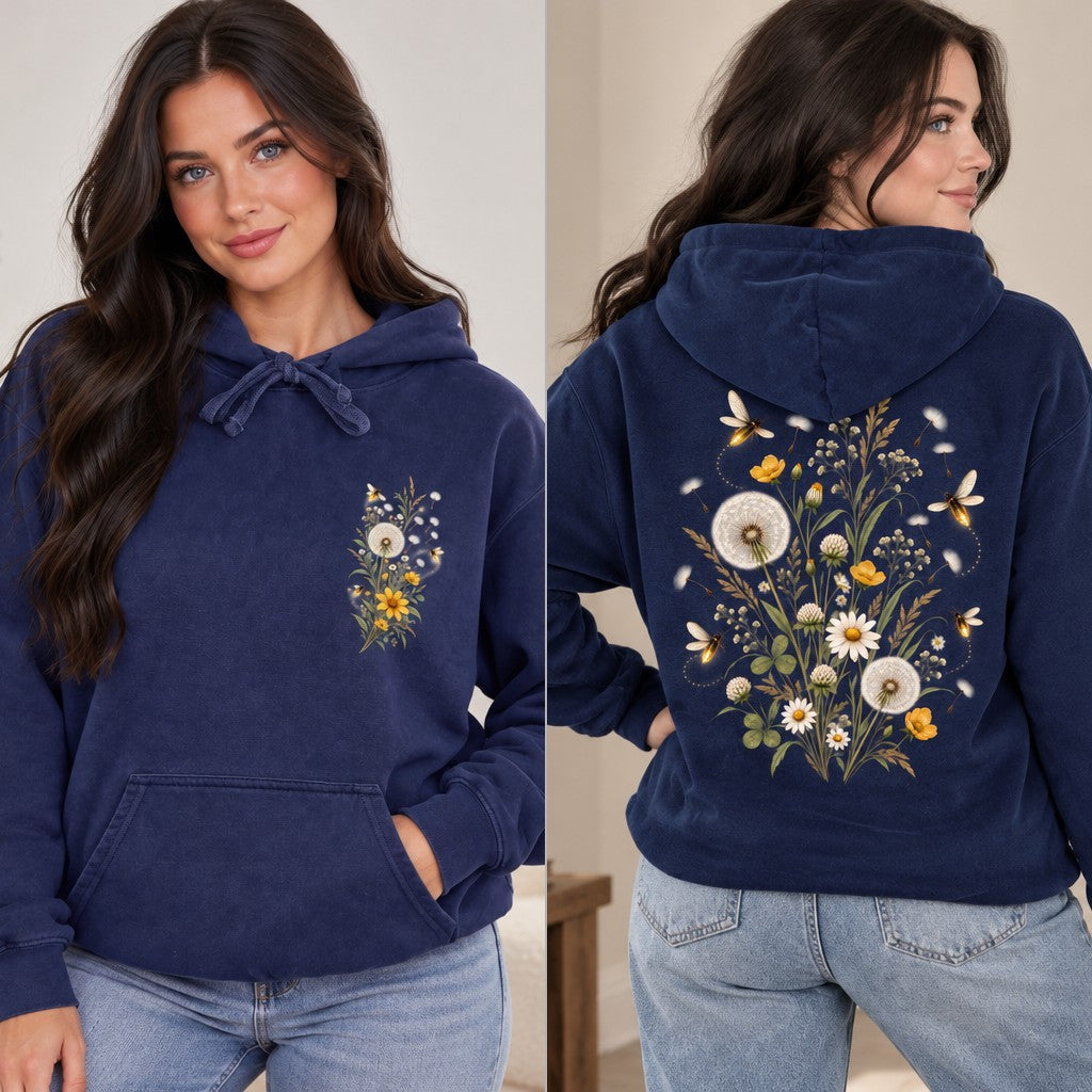 Woman wearing a true navy hoodie with a boho sunshine and floral sun face design, featuring celestial elements and decorative flowers, perfect for women who love whimsical and nature-inspired apparel, outdoor setting, by Crossroads Dandelion