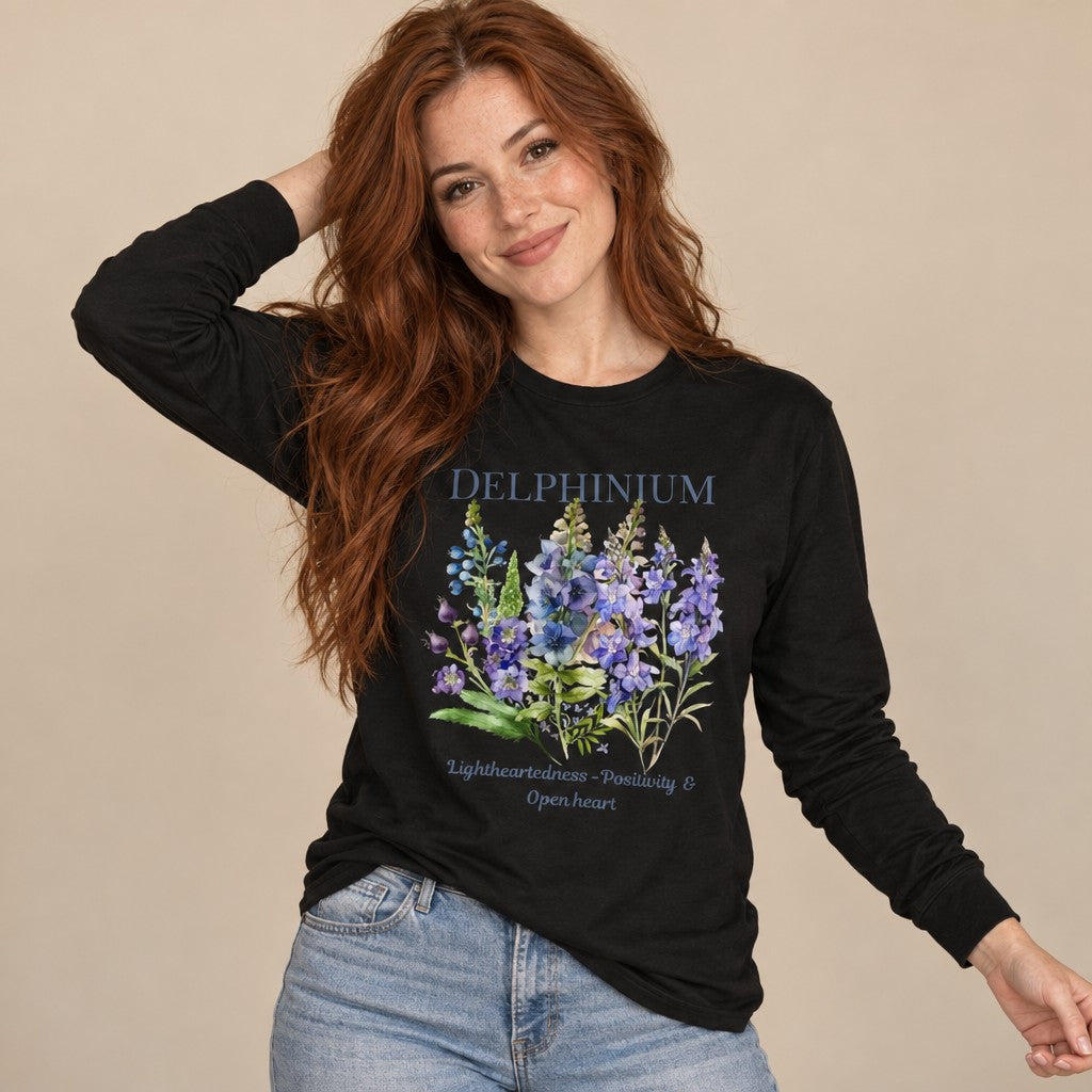 Woman wearing a black long sleeve Bella Canvas 3501 shirt with vintage cottagecore watercolor delphinium and larkspur floral illustration, ideal for plant lovers and botanical enthusiasts, by Crossroads Dandelion