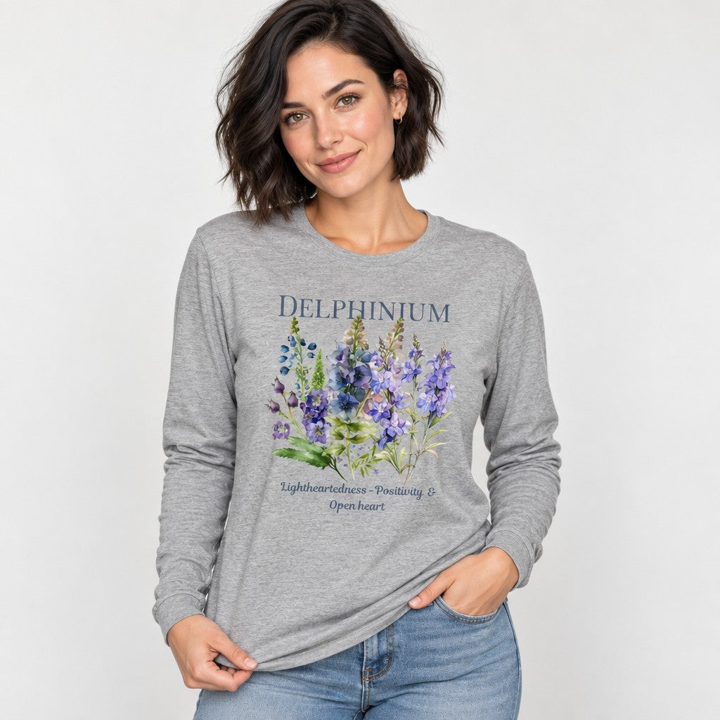 Woman wearing an athletic heather Bella Canvas 3501 long sleeve shirt featuring a vintage-inspired watercolor delphinium floral design with botanical symbolism, dreamy and gentle cottagecore aesthetic, ideal for plant lovers and women, by Crossroads Dandelion