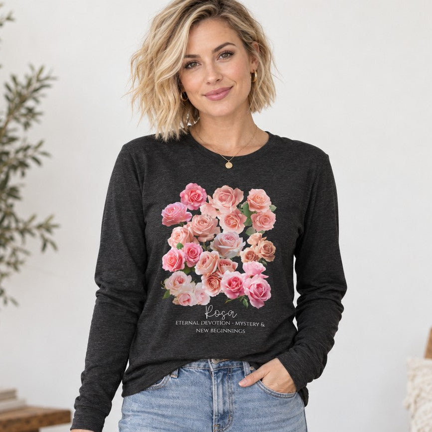 Woman in dark grey heather Bella Canvas 3501 long sleeve shirt featuring a vintage-inspired watercolor pink and blush rose bouquet design, cozy indoor cottage scene, romantic botanical apparel for women, flower lovers and June birthdays, by Crossroads Dandelion