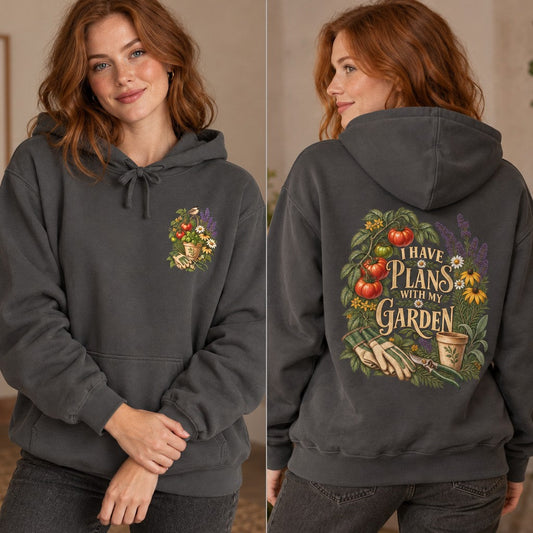 Red-haired woman modeling a pepper-colored hoodie with a cottagecore floral garden illustration and the phrase 'I have plans with my garden,' perfect for gardening enthusiasts and cozy cottage style lovers, by Crossroads Dandelion