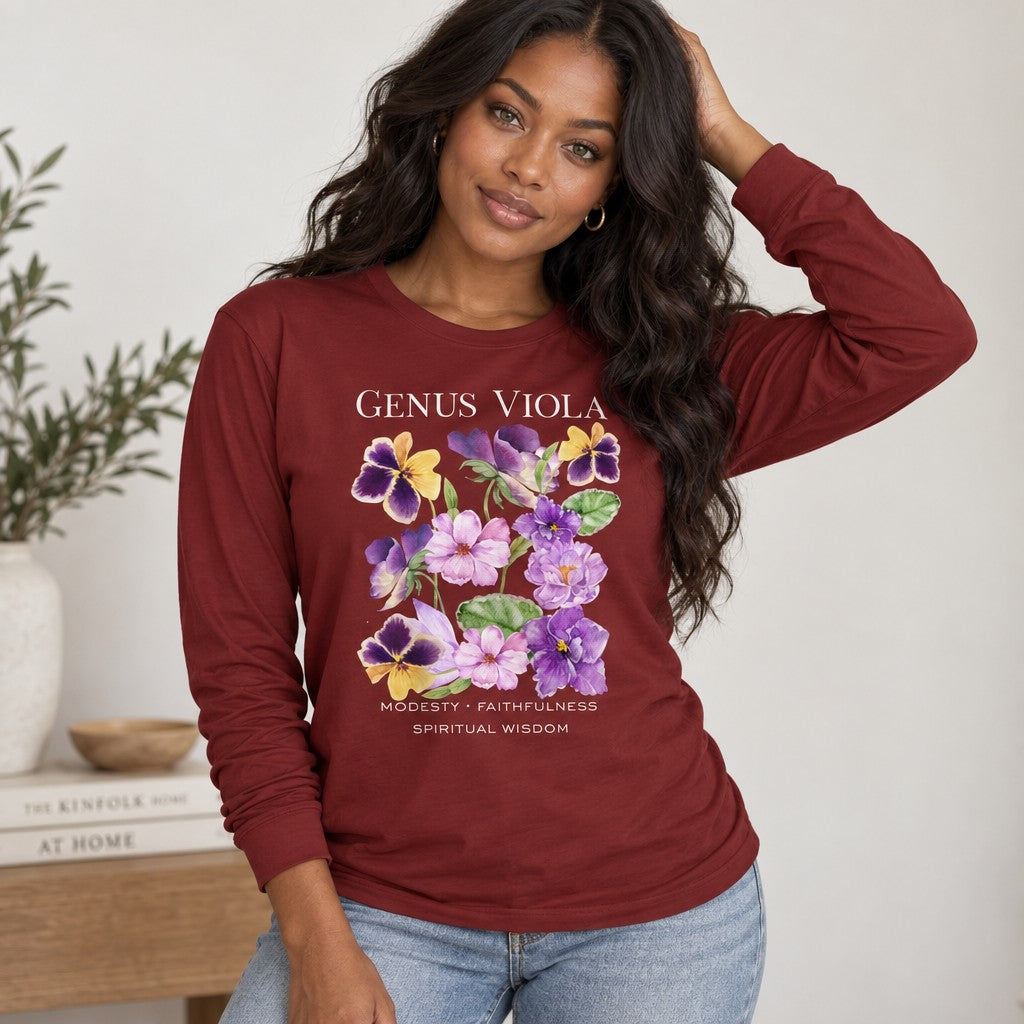 Woman in cardinal red Bella Canvas 3501 long sleeve shirt with cottagecore watercolor bouquet of violets and pansies, vintage botanical symbolism design, cozy home setting, perfect for botanical art lovers and women, by Crossroads Dandelion