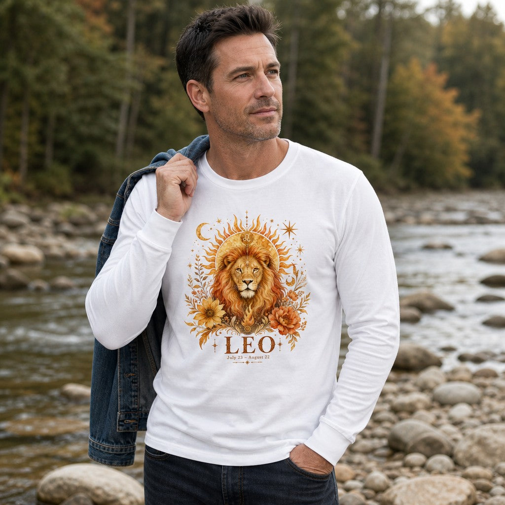 Man in white Bella Canvas 3501 long sleeve featuring a cottagecore Leo zodiac design with a regal lion, golden sunbeams, crescent moons, stars, and lush florals, standing by a river; ideal for astrology lovers, astrology enthusiasts, and wild botanical art fans, by Crossroads Dandelion