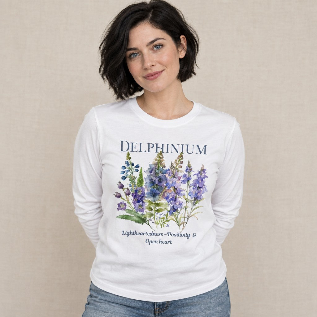 Woman in a white long sleeve Bella Canvas 3501 shirt featuring a vintage-inspired watercolor Larkspur floral design, cottagecore style for botanical and plant lovers, gentle dreamy mood, by Crossroads Dandelion