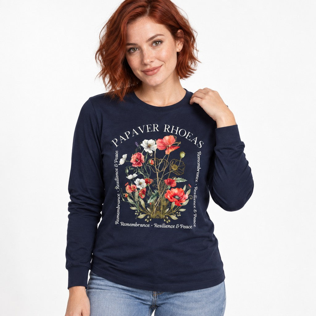 Woman wearing a navy Bella Canvas 3501 long sleeve shirt featuring a lush watercolor poppy floral design with golden botanical line accents and poetic text, cottagecore style, perfect for nature-loving artful souls, by Crossroads Dandelion