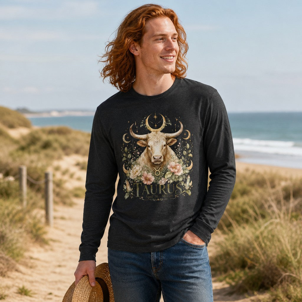 Man wearing dark grey heather Bella Canvas 3501 long sleeve shirt with a watercolor bull, celestial moons, and vintage cottagecore florals, walking along a coastal beach, astrology and nature lovers, by Crossroads Dandelion