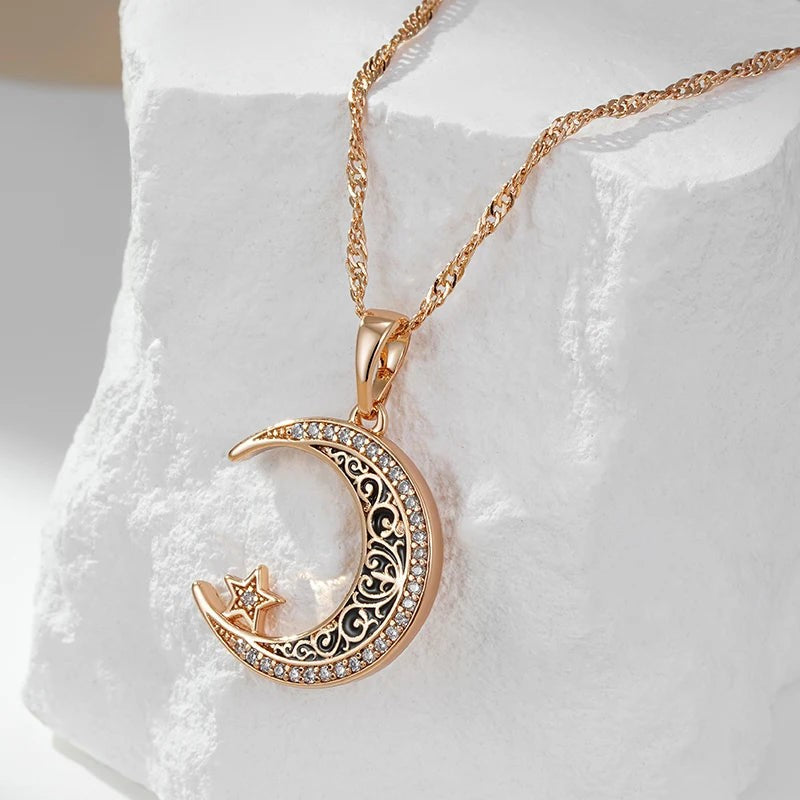 Rose gold crescent moon necklace hanging over white stone
