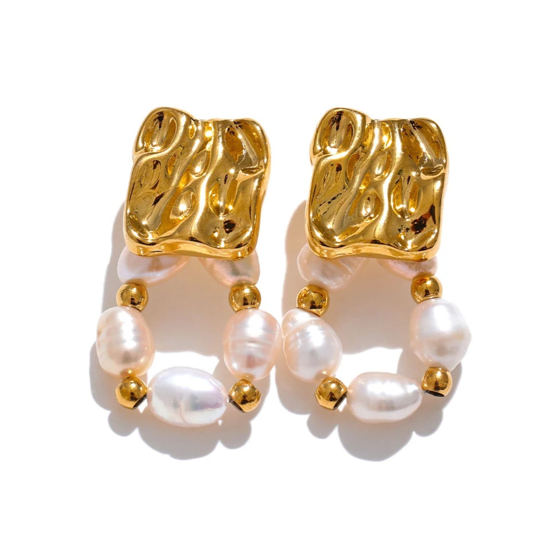 Close-up of freshwater baroque pearl drop earrings in gold PVD plated stainless steel, geometric textured square stud with pearl hoop loop, by Crossroads Dandelion