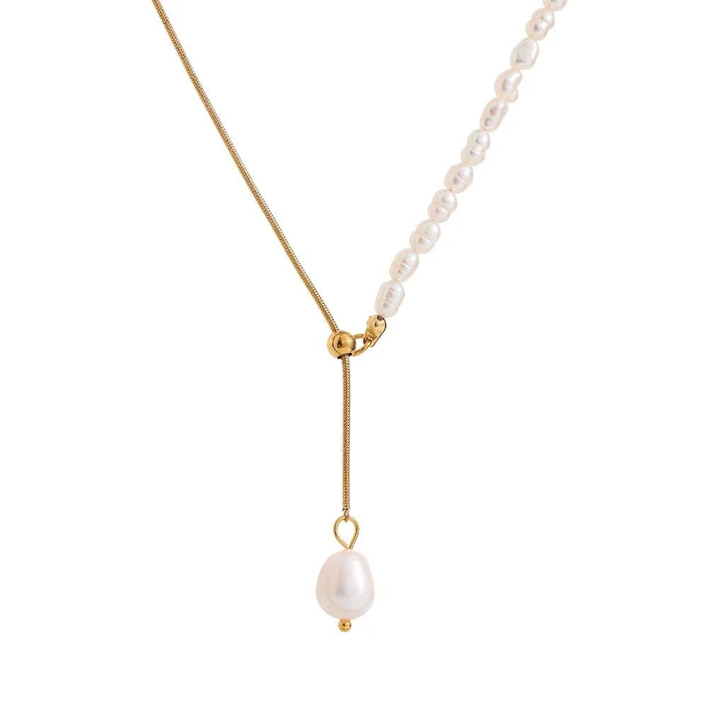 Freshwater pearl lariat necklace with a gold snake chain and baroque pearl drop on white