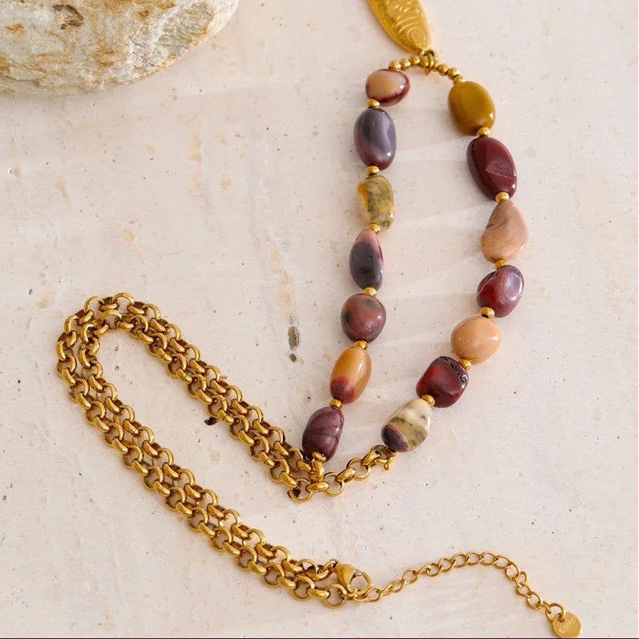 Gold fish pendant necklace laid flat showing the rolo chain, lobster clasp and extender