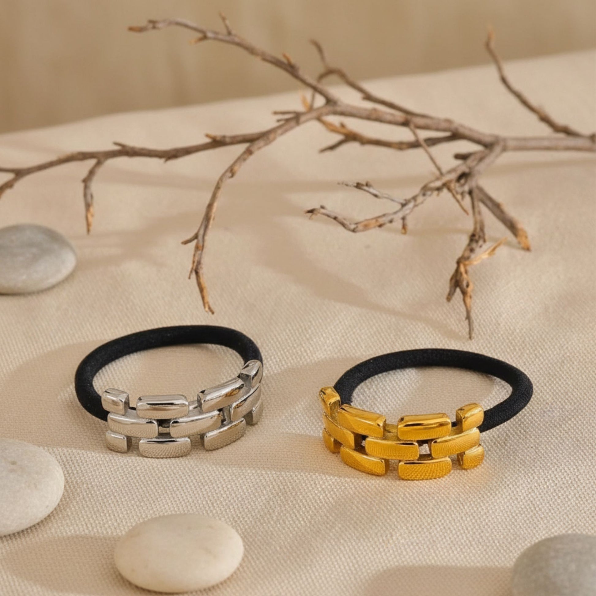Gold and silver hair elastic bands displayed on neutral fabric background, by Crossroads Dandelion