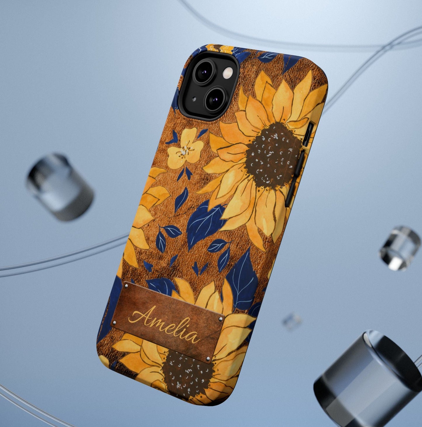 Custom name personalized sunflower western tough phone case for iPhone 14 Plus, featuring bold yellow sunflowers, navy blue leaves, rustic brown faux leather texture background, and a riveted metal name plate — perfect boho cowgirl gift, by Crossroads Dandelion