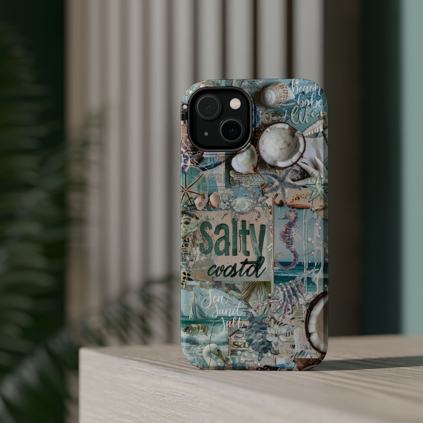 Salty Coastal ocean shells iPhone 14 glossy phone case standing display mockup with nautical turquoise collage design, by Crossroads Dandelion
