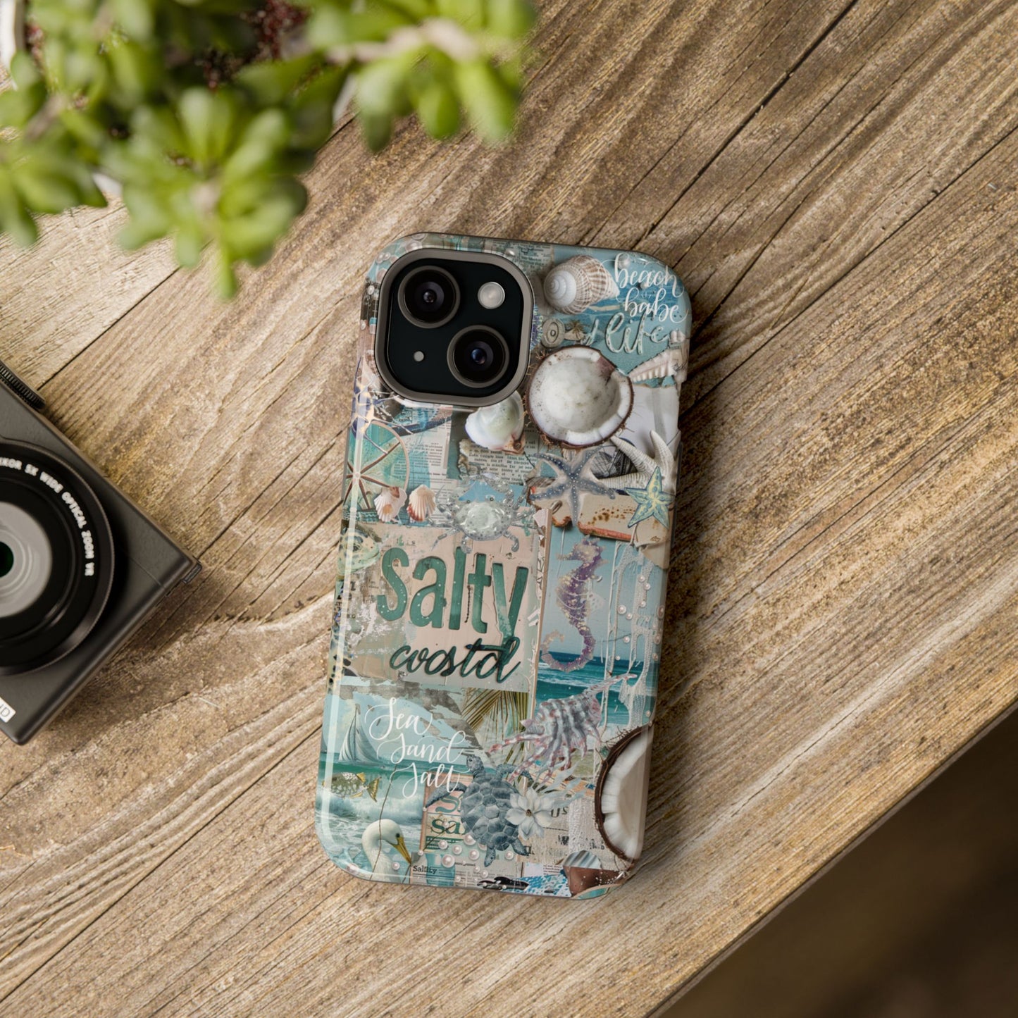 Salty Coastal seashell iPhone 15 glossy phone case mockup styled on rustic wood table with coastal beach aesthetic, by Crossroads Dandelion
