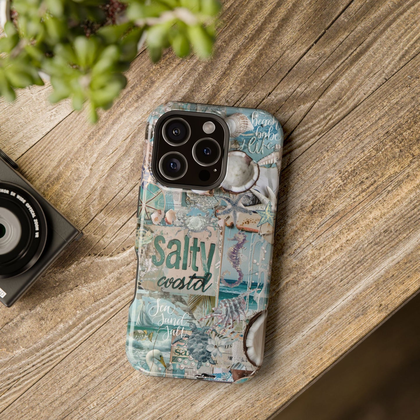 Salty Coastal aqua seashell iPhone 16 Pro glossy phone case mockup with beach-inspired collage design on wooden lifestyle background, by Crossroads Dandelion
