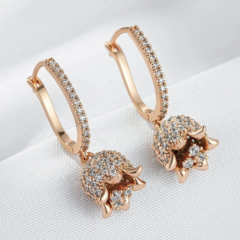 Close-up of the flared rose-gold petals and sparkling stones of lily of the valley earrings