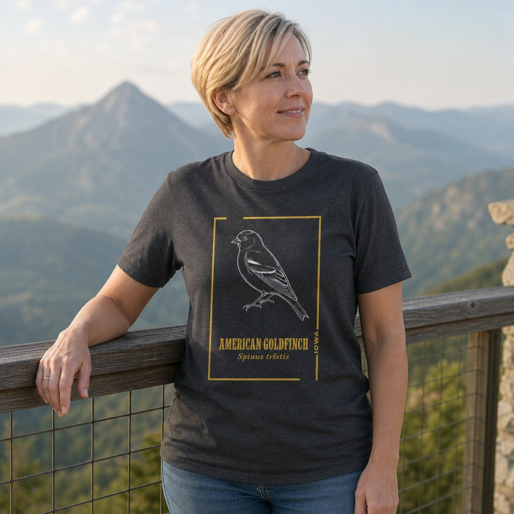 Woman in dark grey heather t-shirt featuring line art American Goldfinch bird illustration and scientific name, minimalist style, standing by a mountain overlook, perfect for bird watchers and nature enthusiasts, by Crossroads Dandelion