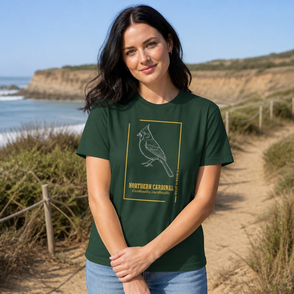 Woman wearing a forest green t-shirt with a minimalist line art northern cardinal bird design and scientific name, standing on a scenic coastal path near the beach, perfect for nature lovers and bird enthusiasts, by Crossroads Dandelion