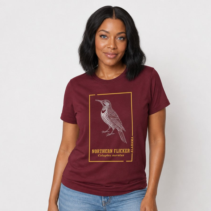 Woman wearing a maroon Bella Canvas 3001 t-shirt featuring a vintage botanical line art illustration of a Northern Flicker woodpecker with stippled textures and botanical detailing, cottagecore and birdwatching inspired, for nature lovers, by Crossroads Dandelion