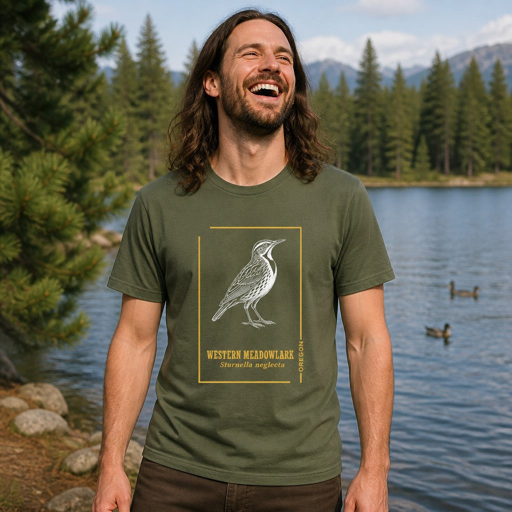 Man wearing a military green Bella Canvas 3001 t-shirt with intricate line art of a Western Meadowlark framed in golden ochre, vintage field guide style, lakeside pine forest scene, perfect for male Oregon nature lovers, birdwatchers, and cottagecore wildlife fans, by Crossroads Dandelion