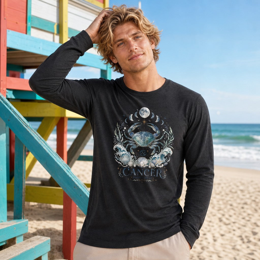 Man wearing a dark grey heather long sleeve Bella Canvas 3501 with a watercolor celestial crab and Cancer zodiac design, moon phases, seashells, and oceanic elements, standing by colorful beach lifeguard tower, coastal astrology apparel for men, by Crossroads Dandelion