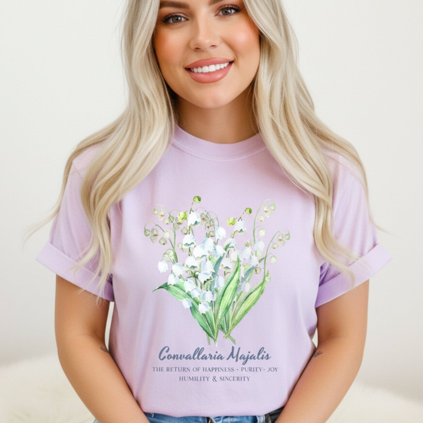 Woman wearing an Orchid floral Lily of the Valley May birthday gift shirt – Crossroads Dandelion