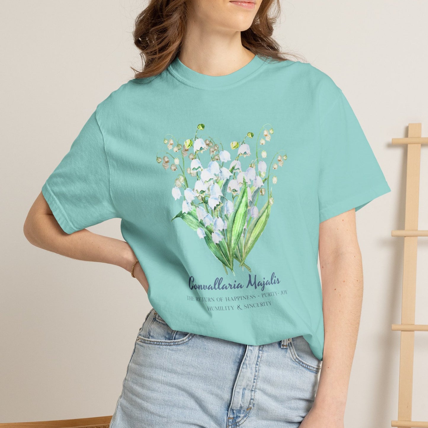Woman wearing a Chalky Mint Lily of the Valley purity and joy birth flower tee – Crossroads Dandelion