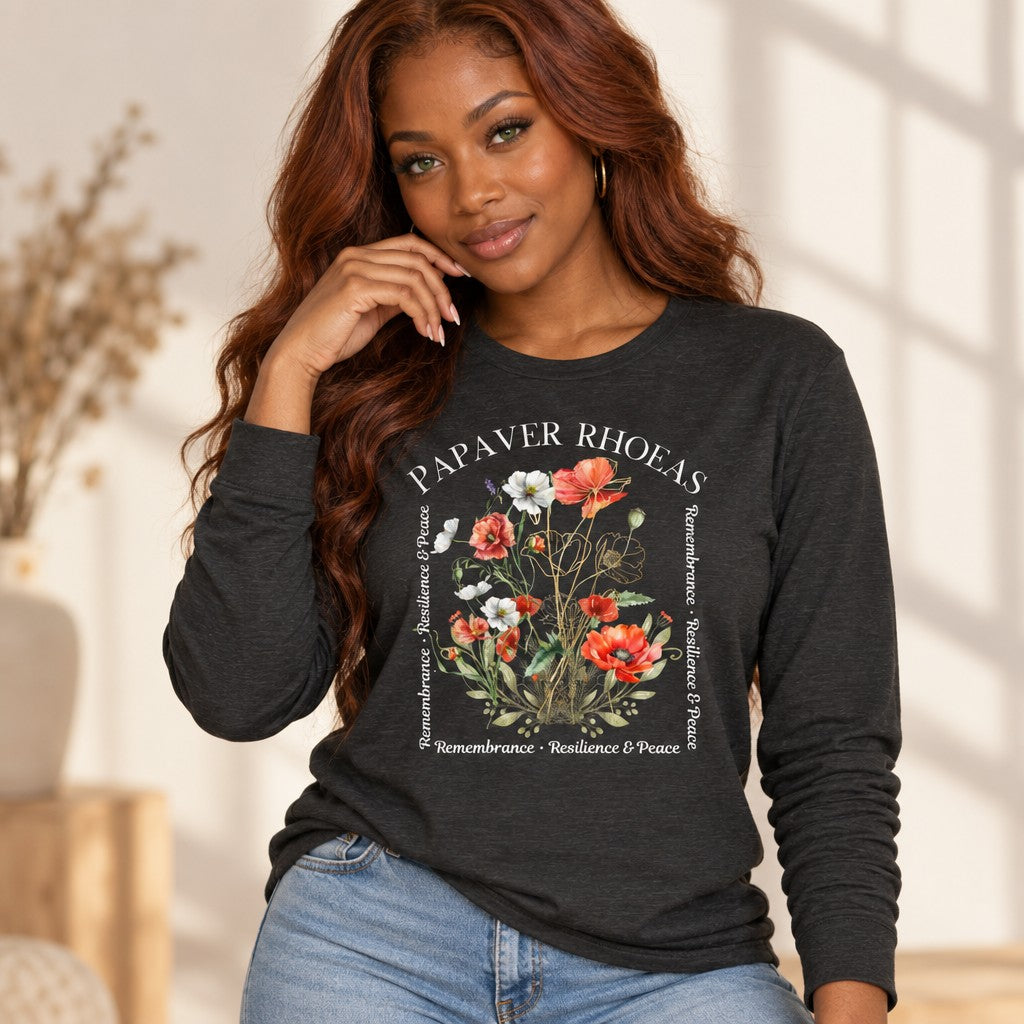 Woman wearing a dark grey heather Bella Canvas 3501 long sleeve shirt with a cottagecore watercolor poppy floral design, poetic golden botanical line art and remembrance motif, for women who love nature and artful style, by Crossroads Dandelion