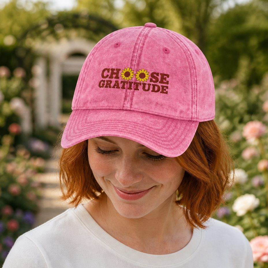 Woman wearing a pink retro baseball cap with embroidered 'choose gratitude' text and sunflowers, cottagecore floral design, in a garden setting, ideal for women seeking positive affirmation accessories, by Crossroads Dandelion