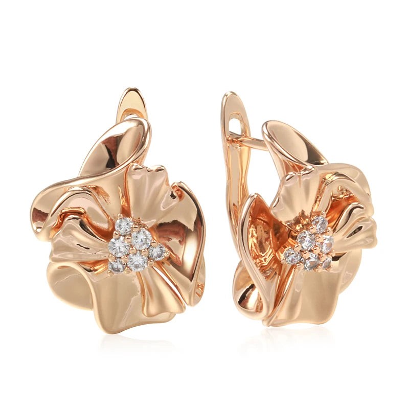 Pair of glossy rose gold ruffled flower earrings with a clear zirconia cluster, front and side view