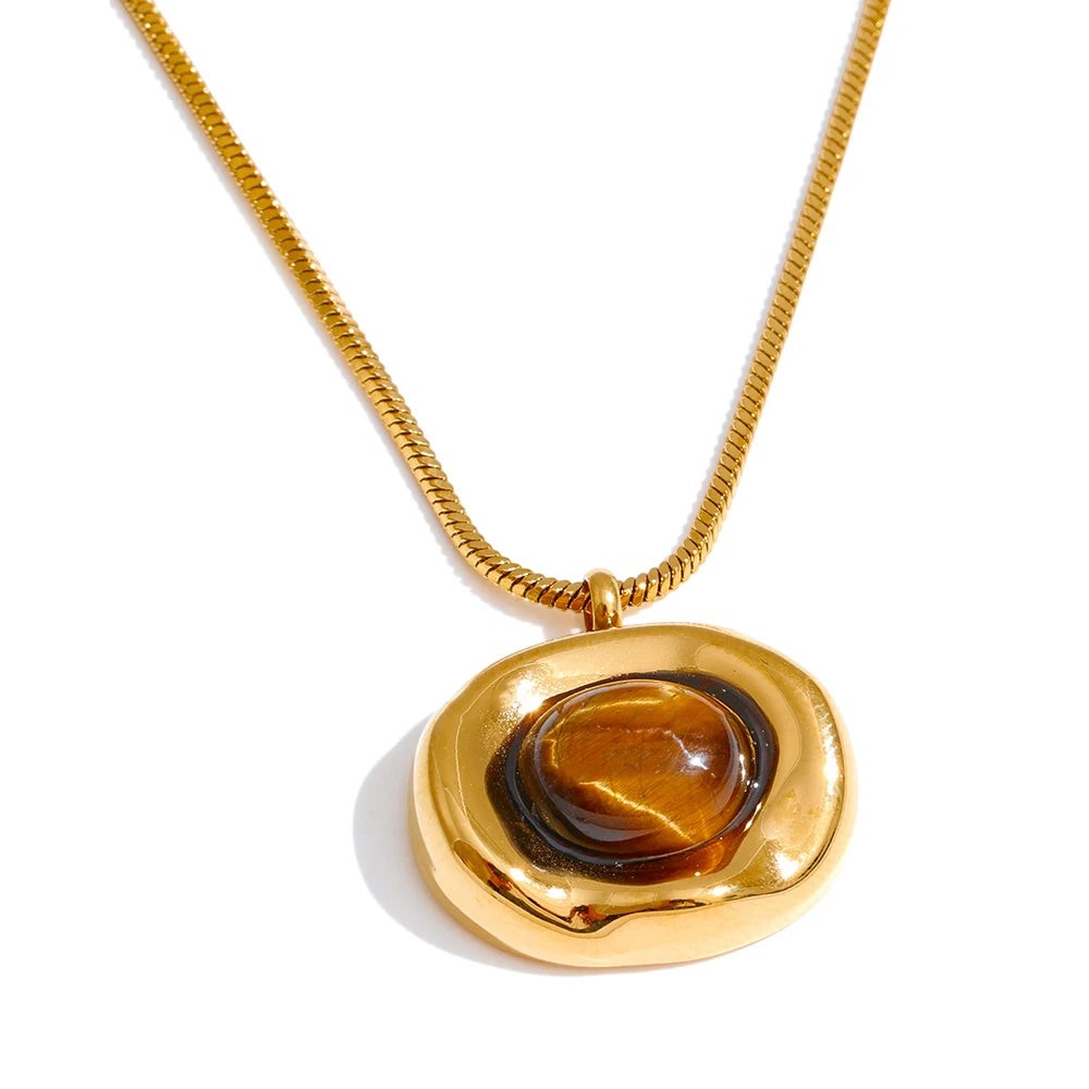 Gold organic pebble pendant with a tiger eye cabochon on a snake chain, front view on white