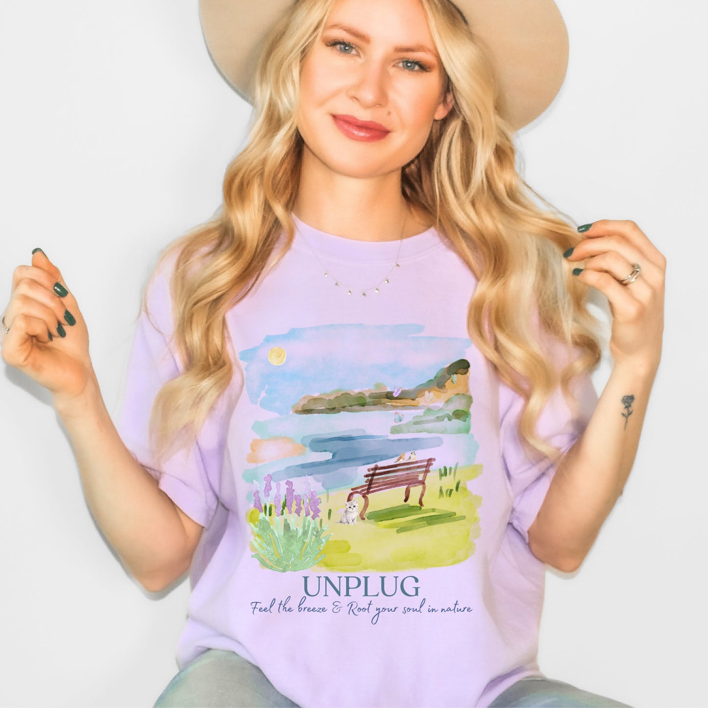 Woman wearing a purple t-shirt with a nature graphic and 'UNPLUG' text.
Comfort Colors garment-dyed nature tee in Orchid color – unplug watercolor lake shirt by Crossroads Dandelion