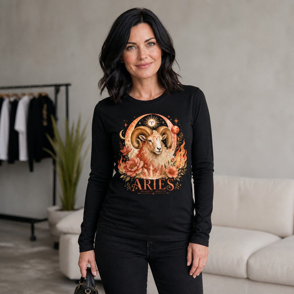 Woman in a black Bella Canvas 3501 long sleeve shirt featuring a vintage watercolor Aries ram surrounded by fiery florals, sun, moon, and handwritten zodiac motifs, in a modern living room, perfect for astrology lovers, by Crossroads Dandelion