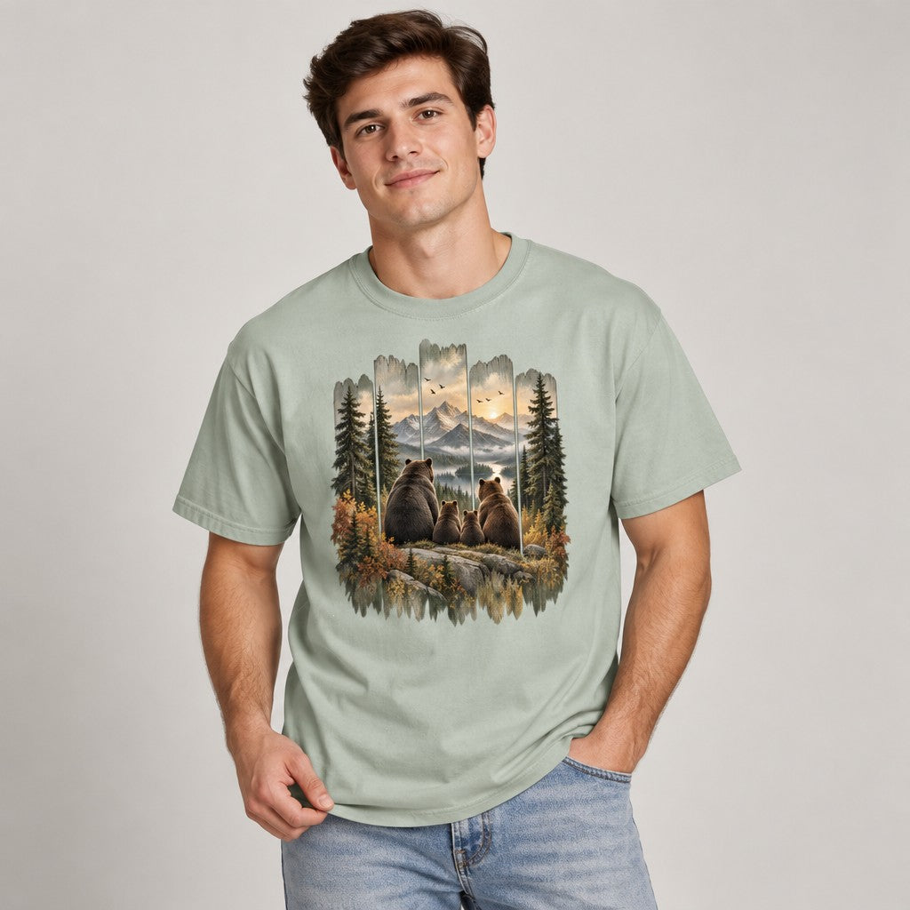 Man wearing bay Comfort Colors® t-shirt featuring a vintage-style painted bear family gazing at mountain sunset, rustic cabin art with wood-panel frame, ideal for hikers, campers, and nature lovers, by Crossroads Dandelion